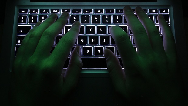 A man types on a computer keyboard in Warsaw in this February 28, 2013 illustration file picture.  High-level Chinese hackers recently tried to break into a key Canadian computer system, forcing Ottawa to isolate it from the main government network, a senior official said on July 29, 2014. REUTERS/Kacper Pempel/Files (POLAND - Tags: BUSINESS SCIENCE TECHNOLOGY)
